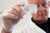 Man holding urine sample