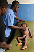 Doctor examining a child,Sierra Leone