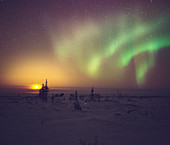 Aurora borealis display with setting Moon