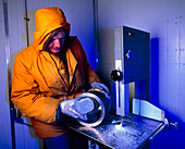 Scientist in a cold room with an ice core