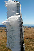 Ice on mountain signpost