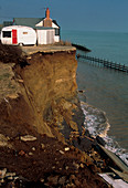 House perched at the top of a sea eroded cliff