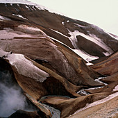 River cutting through an ash layer at volcano base