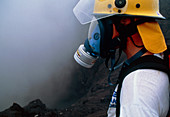 Volcanologist wearing gas mask