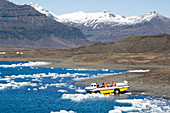 Tourist boat entering glacial lake