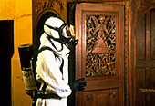 Technician about to fumigate a wooden church door