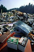Discarded car batteries in a scrap metal pile