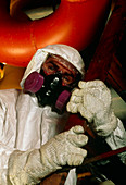 Technician wearing suit to protect from asbestos