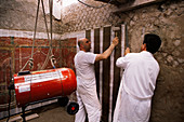 Archaeologists with a fresco,Pompeii