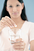 Woman taking a soluble pill