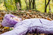 Girl lying on autumn leaves