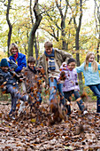 Parents and children playing in a wood