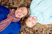 Mother and daughter on autumn leaves