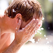 Man washing his face