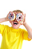 Boy playing with doughnuts