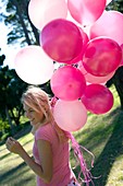 Happy Woman holding balloons