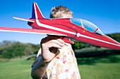 Boy playing with a model aeroplane