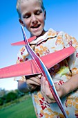 Boy playing with a model aeroplane