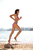Woman jogging on a beach