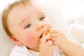 Baby boy eating a crisp