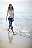 Woman walking along a beach