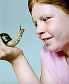 Girl holding a giant snail
