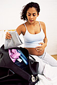 Pregnant woman packing bag