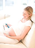 Pregnant woman using a doppler monitor