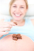 Pregnant woman eating chocolate