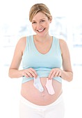 Pregnant woman holding booties