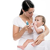 Baby using an asthma spacer