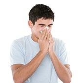 Teenage boy sneezing