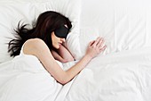 Young woman sleeping with sleep mask