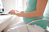 Pregnant woman using a computer