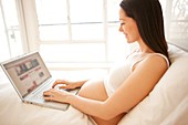 Pregnant woman using a laptop