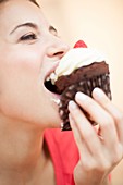 Woman eating a cup cake