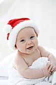 Baby boy wearing Santa hat