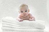 Baby boy lying on towels