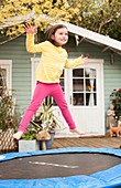 Girl bouncing on a trampoline