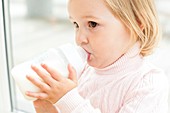 Toddler holding a bottle of milk