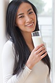Woman holding glass of milk