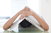 Woman and laptop over her head