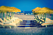 Sunloungers and parasols on a beach