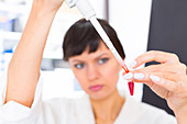 Lab assistant holding test tube