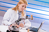 Female student working in a robotics lab