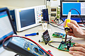 Person working in an electronics lab