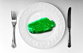 Green meat on white plate