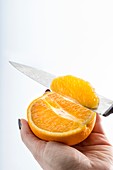 Person slicing an orange