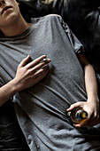 Young man holding beer and cigarette