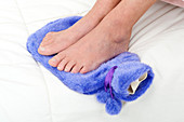 Woman with feet on hot water bottle